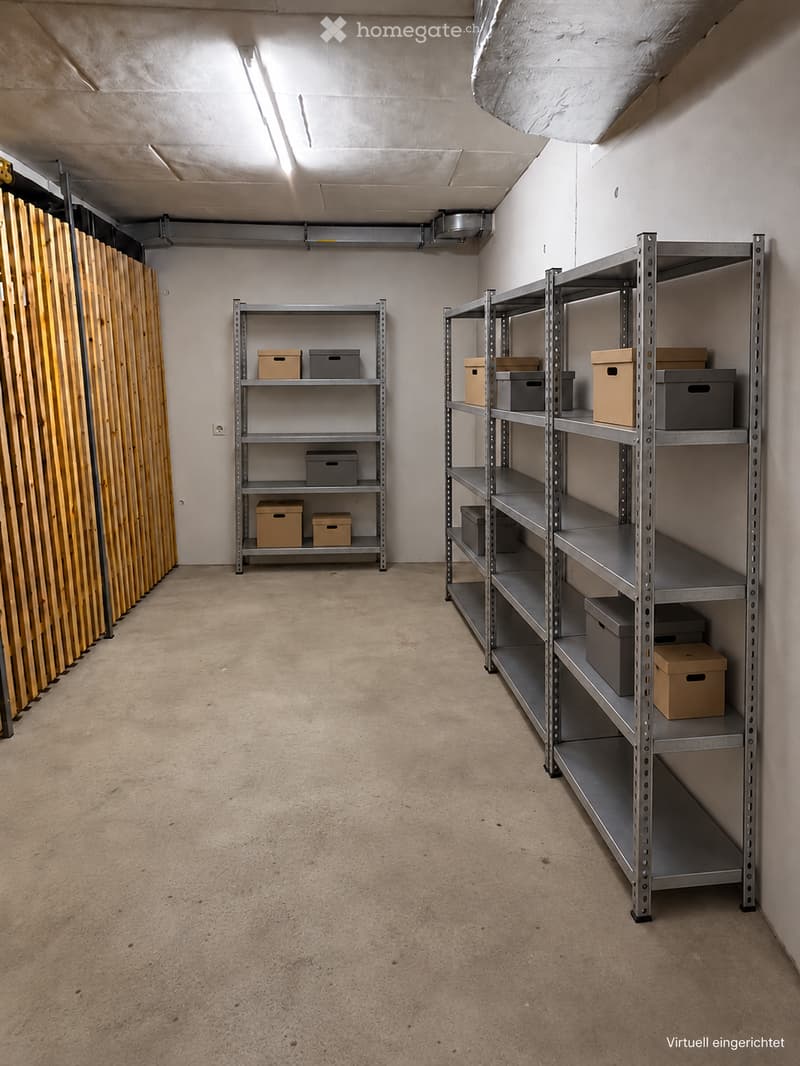 Empty storage room with metal shelving units and cardboard boxes, wooden panel walls, and a concrete floor.