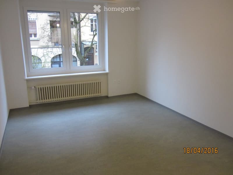 Unfurnished Room. Empty room with light-colored walls, carpeted floor, and a window with a radiator below it.
