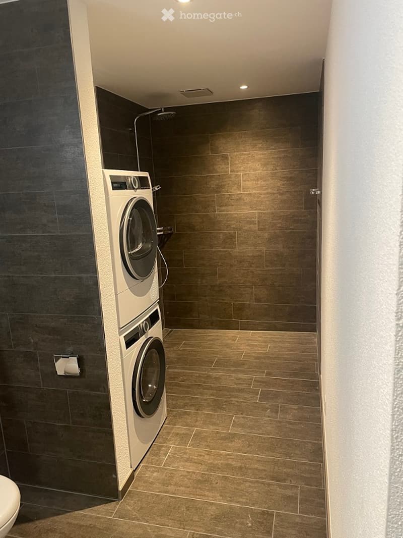 White appliances on tile walls and tiled floor