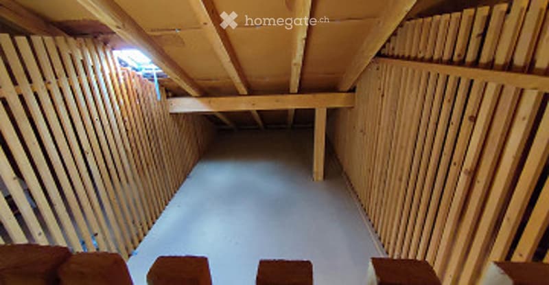Empty attic space with exposed wooden beams and walls, unfinished interior, no furniture or equipment.
