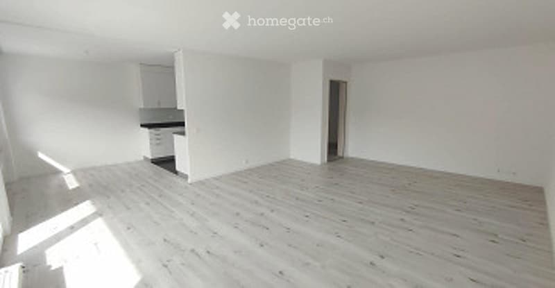 Completely empty room with white walls and wooden floor. No furniture or equipment.