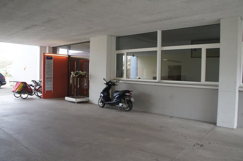concrete floor, entrance, large windows, moped, bicycle with a trailer, car