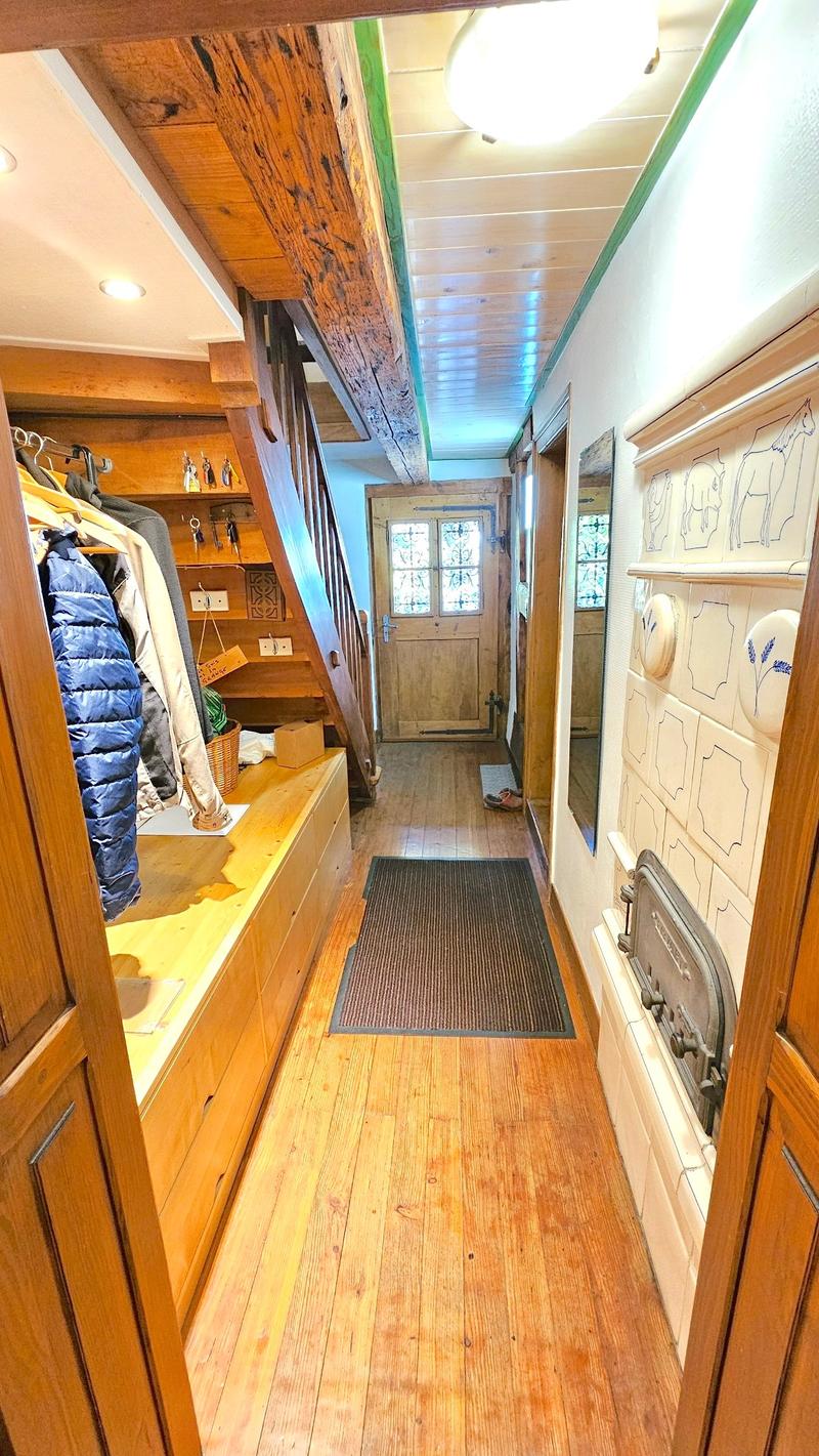 wooden floor, coat rack, rug, fireplace, staircase, window