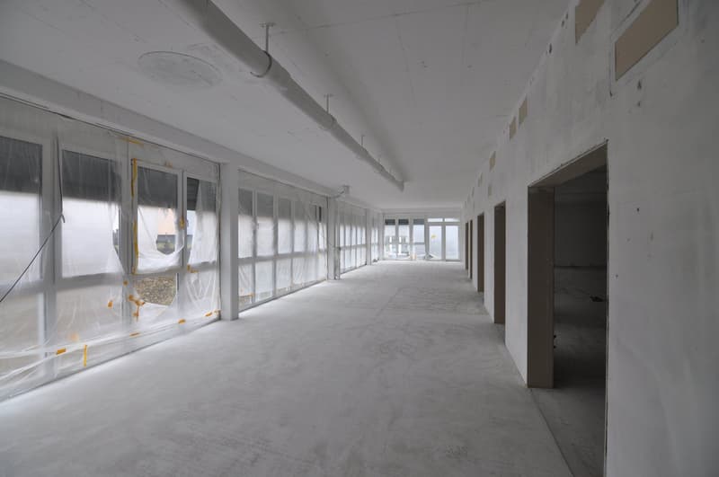 unfinished room, glass windows, concrete floor, white walls, exposed ceiling pipes