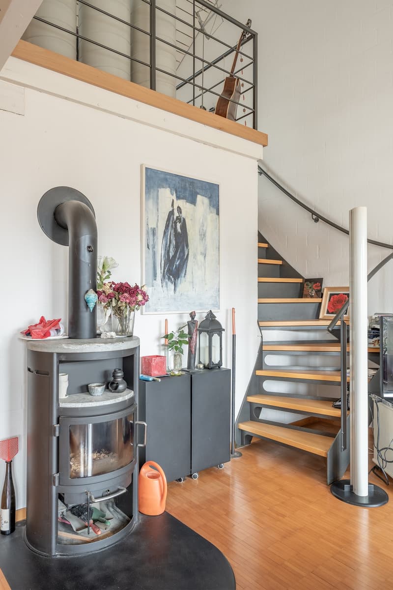 Fireplace, wooden floor, staircase, wall paintings, plant, vase, decorations