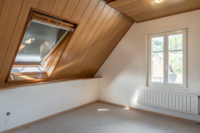 empty room, wooden ceiling, two windows, white walls, white radiator, power outlet