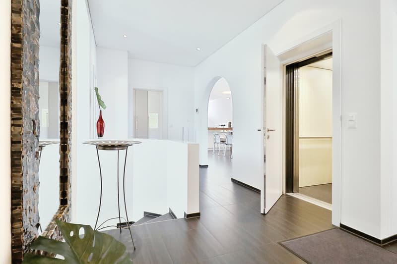 elevator, modern design, tiled floor, arched doorway, open room, stairs