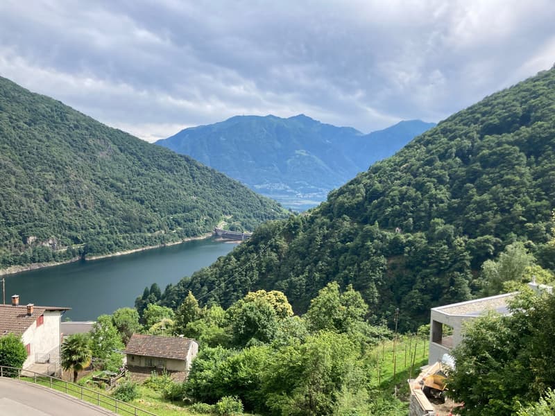 Mountains, lake, houses, trees, cloudy sky