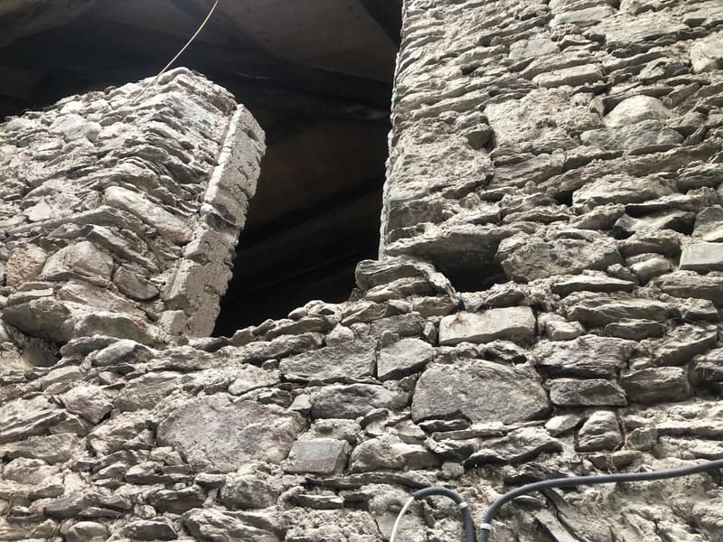 Stone walls, open hole, wires hanging down
