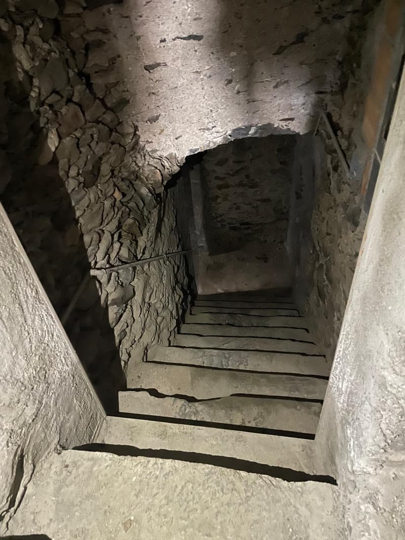 stone walls, concrete steps, narrow stairs, stone ceiling