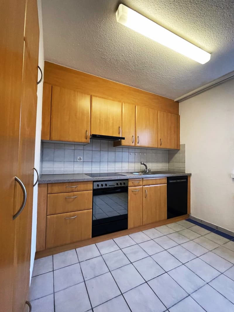 modern kitchen with wooden cabinets, white tiles, electric stove, dishwasher, sink, faucet, and a dishwasher