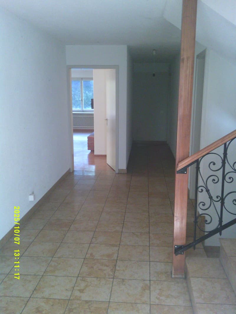 empty hallway with white walls, wooden floors, tile floors, white ceiling