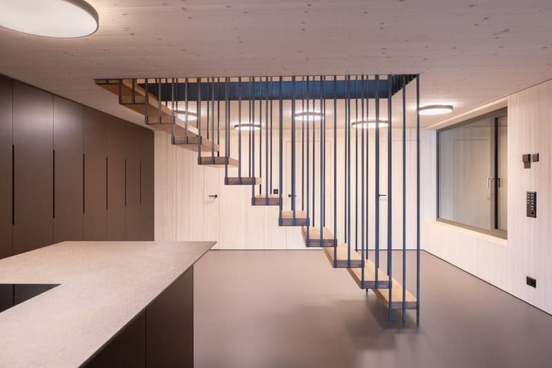 modern staircase, wooden steps, metal railings, white ceiling, wooden walls, kitchen countertop