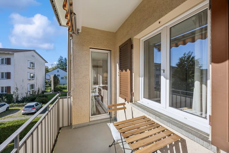 balcony with railing, wooden bench, chairs, window, white curtains