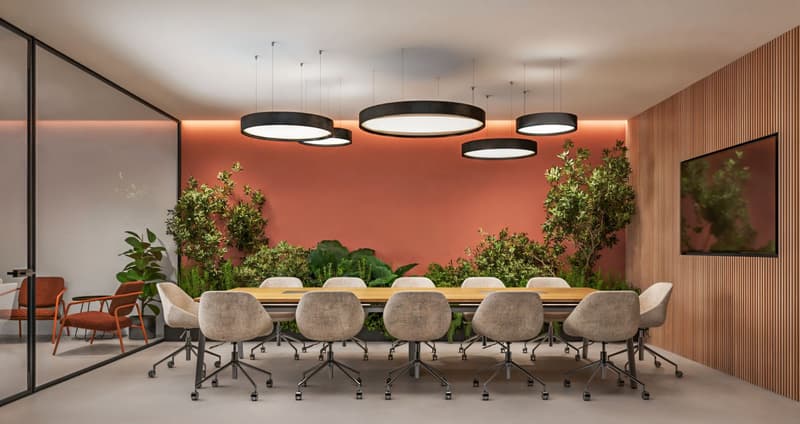 modern meeting room with large table, chairs, plants, red wall, ceiling lights, monitor