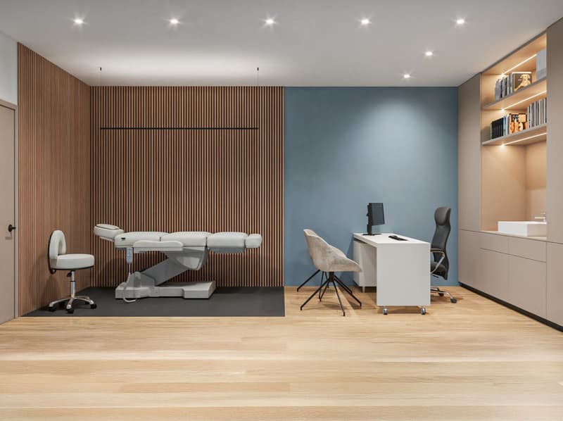 modern medical room with wooden wall, blue wall, white desk, chairs, medical bed, wooden floor
