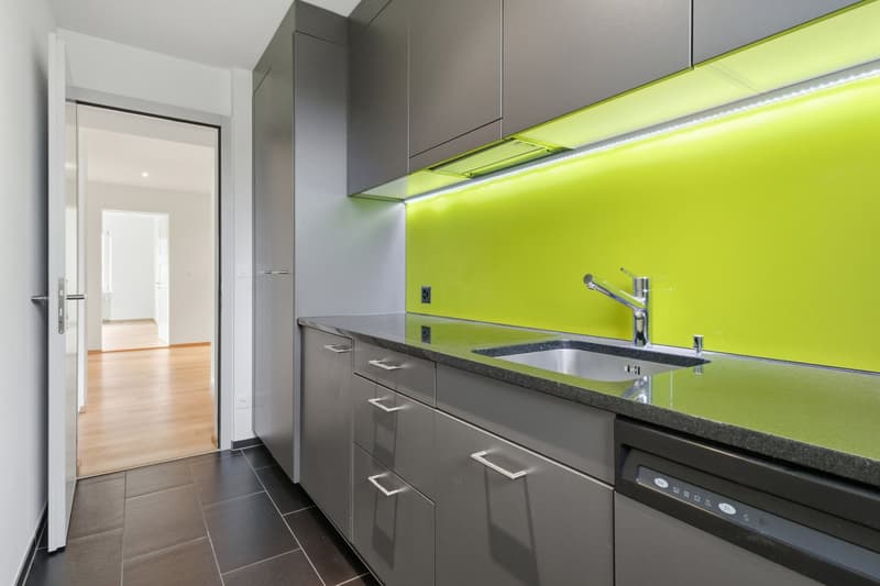 modern kitchen with yellow backsplash, stainless steel cabinets, granite countertop, stainless steel sink, faucet, dishwasher, power outlet, tiled floor