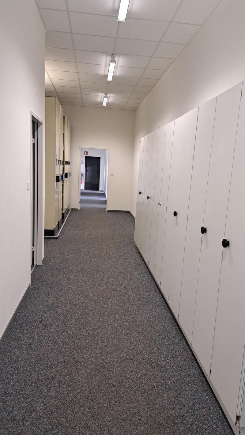 hallway, carpeted floor, two rows of lockers, hallway to the end