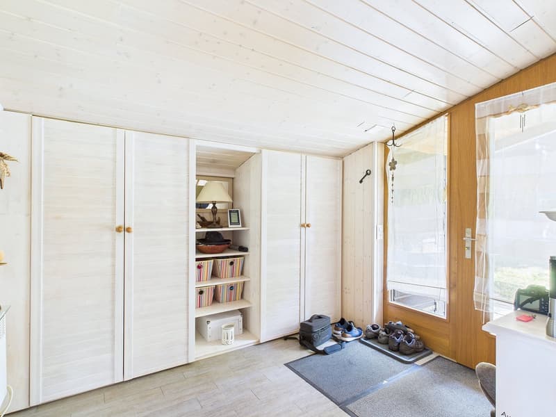white wooden closets, shelves with baskets, lamp, slippers, mat, storage box, small boxes, bag, small items, window