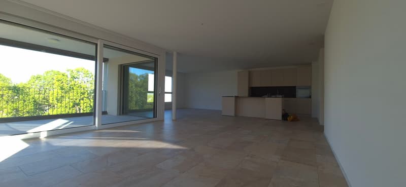 Open floor plan, large windows, balcony, tiled floor, kitchen island, modern appliances