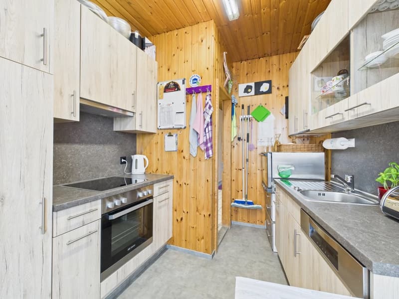 kitchen with wooden walls, electric stove, dishwasher, washing machine, wooden cabinets, granite countertop