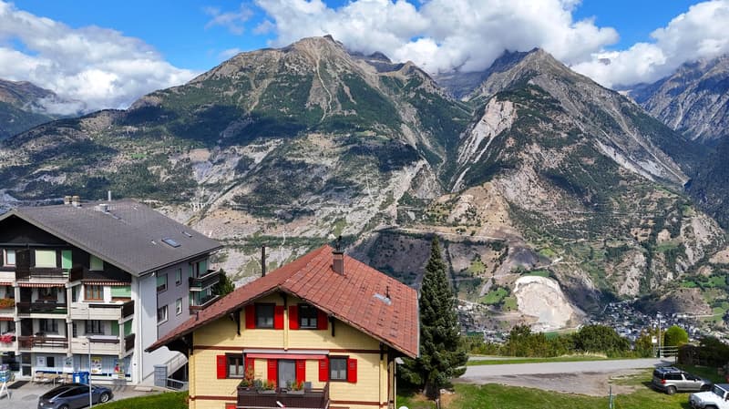 2 houses with mountains in the background