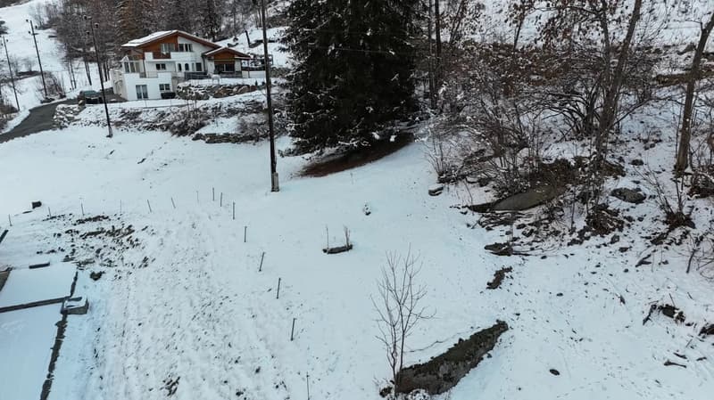 empty snowy slope, snow on the ground, no plants or trees