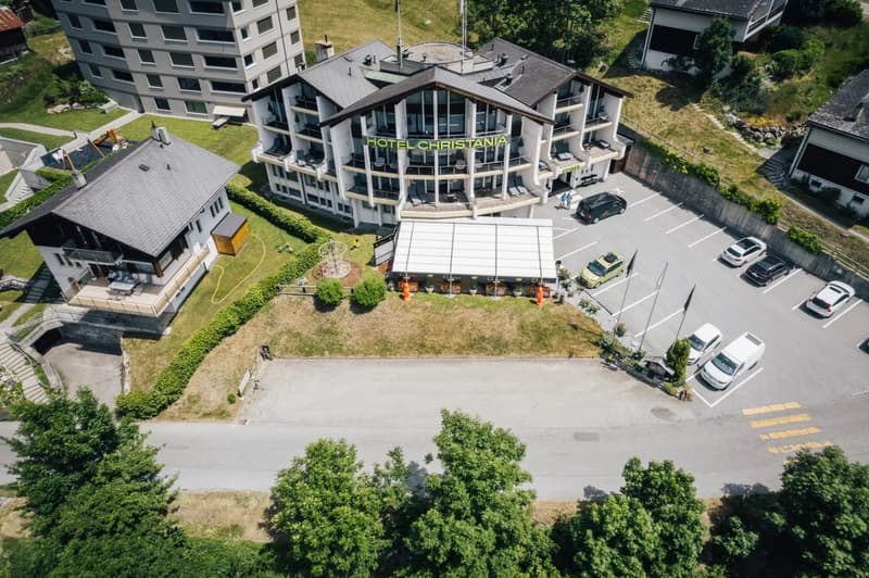 Hotel Christiania, multiple buildings, parking lot, outdoor seating, trees, playground