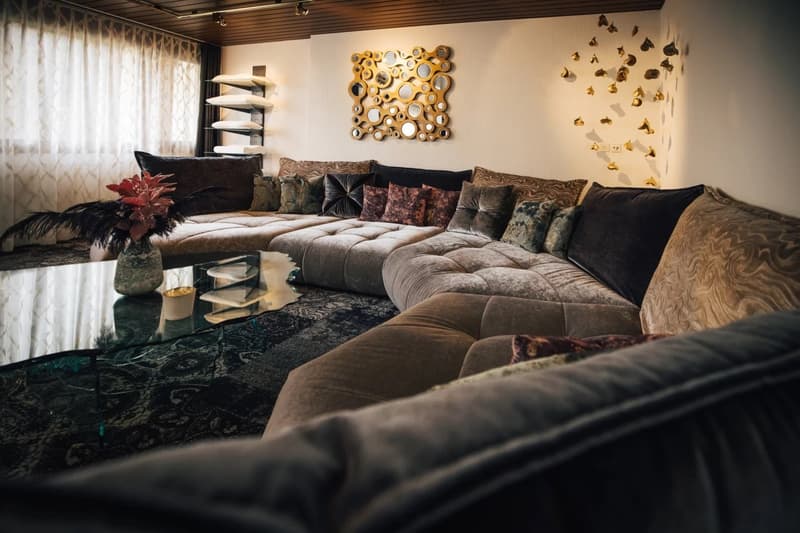L-shaped sofa, glass table, decorative wall art, large windows, decorative pillows, floor lamp
