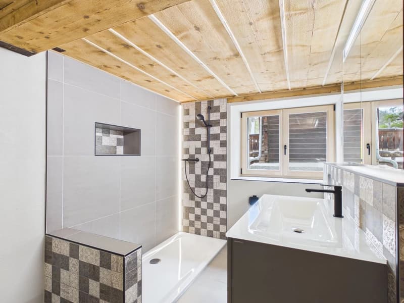 Bathroom with white tiles, wooden ceiling, shower, sink, and window