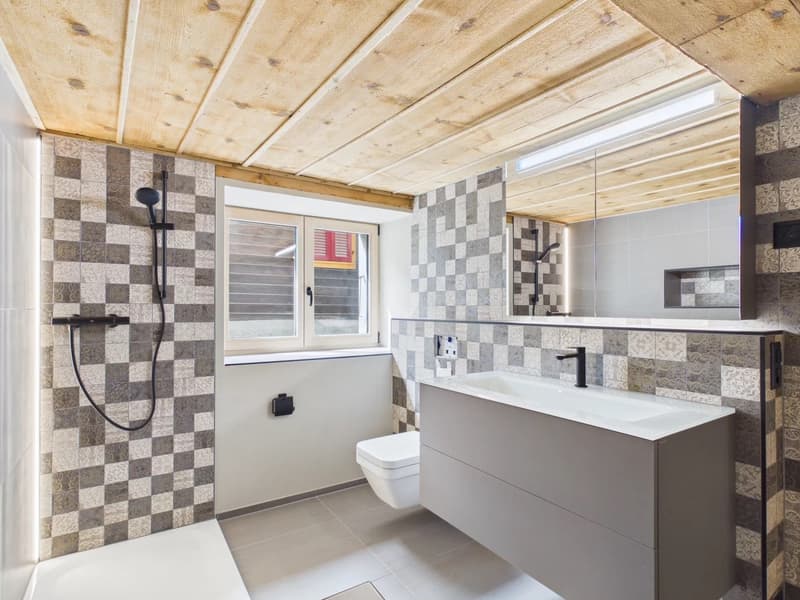 modern bathroom with wooden ceiling, checkered tiles, white sink, toilet, shower, mirror