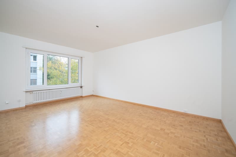empty room, wooden floor, white walls, large window, radiator