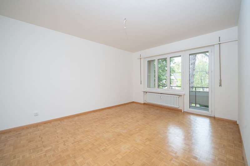 empty room, wooden floor, white walls, sliding glass door, balcony, radiator
