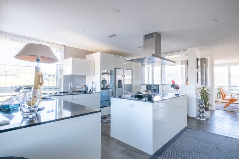 modern kitchen with appliances, white cabinets, countertops, islands, large windows, view outside