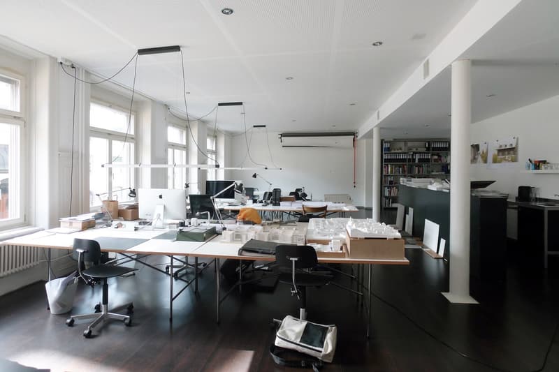 office space with desks, chairs, computer monitors, bookshelves, windows, radiator