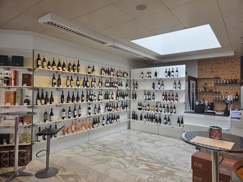 marble floor, white wine shelves, wooden counter, large windows