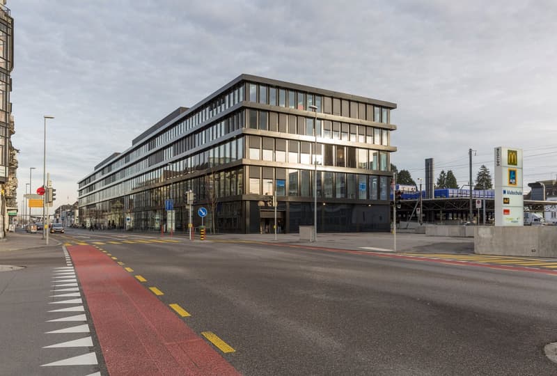 modern office building with glass walls and black facade