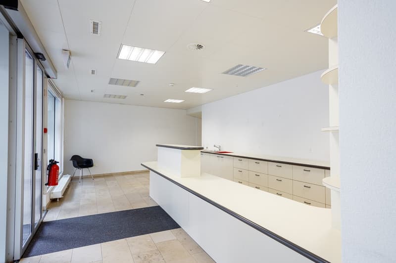 tiled floor, white walls, reception desk, cabinets, fire extinguisher, sink