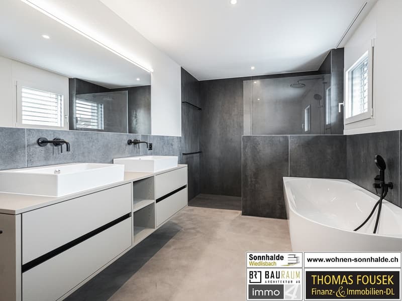 white bathtub, two white sinks, gray tiled walls, modern style