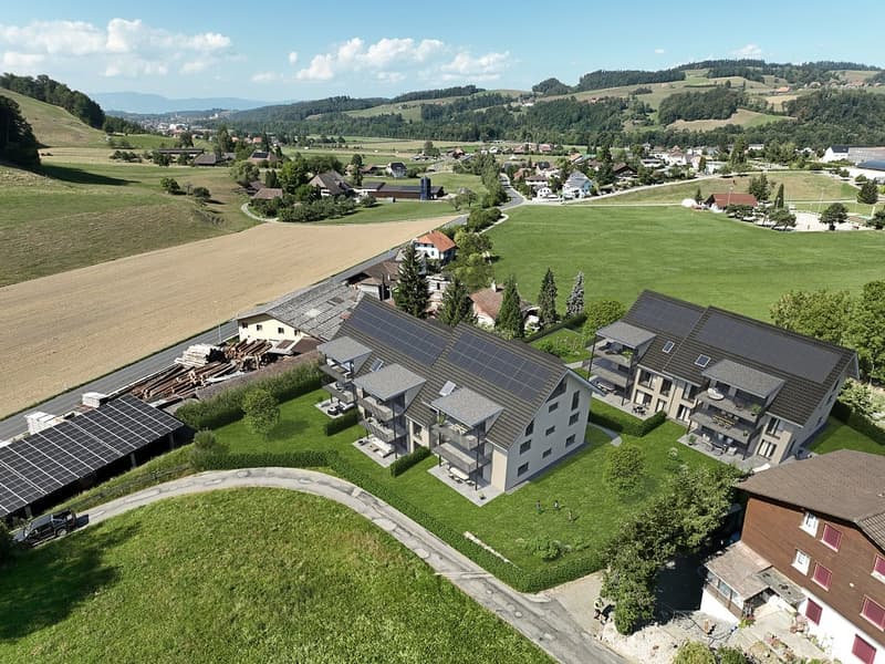 Two-story residential building with solar panels, large windows, and a small yard.
