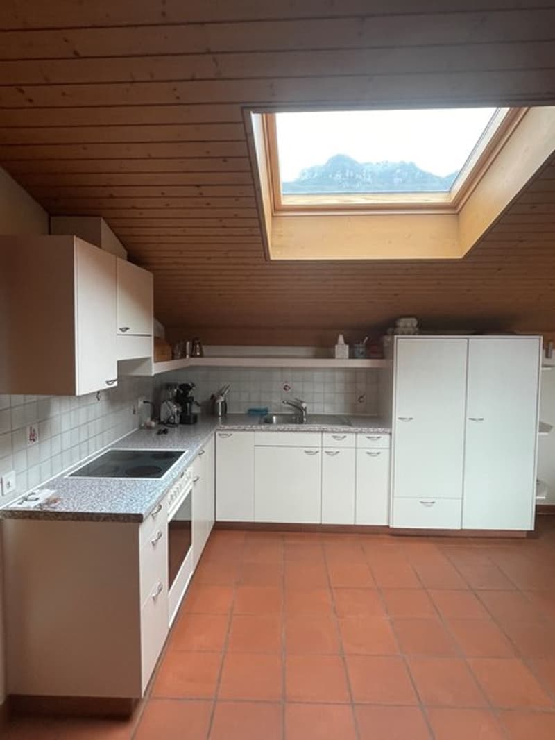 White cabinets, granite countertops, stainless steel appliances, skylight, tiled floor, sink with faucet