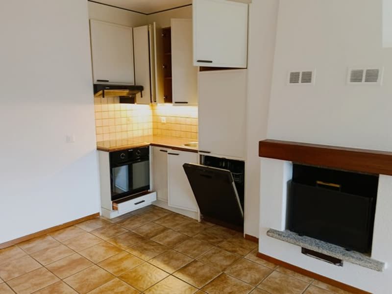 open plan kitchen with dishwasher, oven, and fireplace