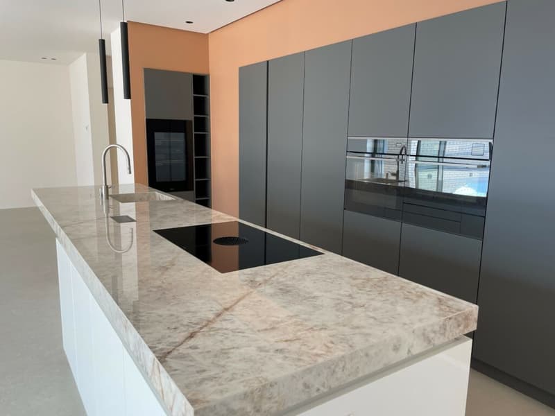 modern kitchen, marble countertop, white cabinets, black induction stove, grey walls, open shelving