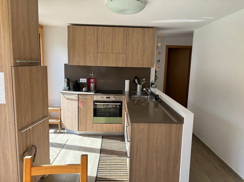 modern kitchen, wooden cabinets, stainless steel appliances, granite countertop, white walls, breakfast bar