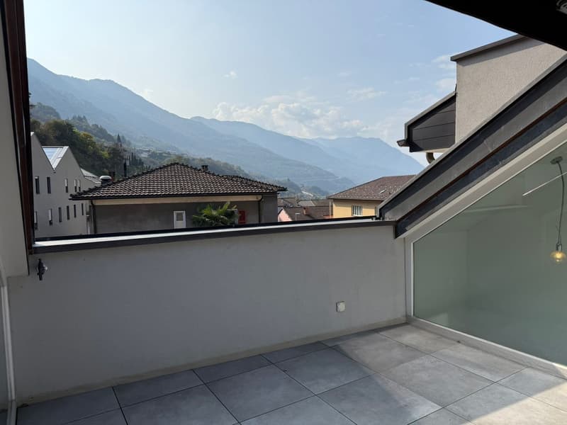 Balcony with a tiled floor and a view of the mountains.