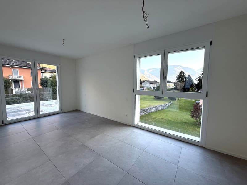 empty room, tiled floor, sliding glass doors, large windows, view of grassy area and mountains