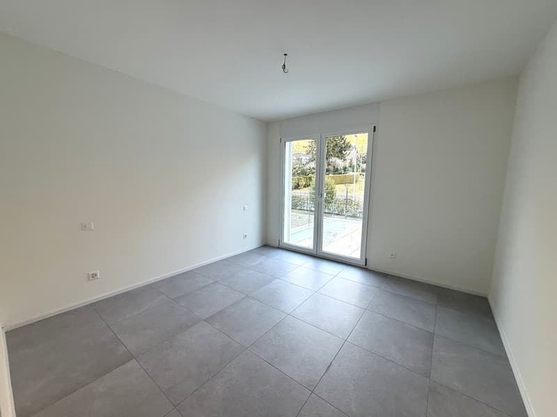 empty room, gray tiles, sliding glass door leading to terrace