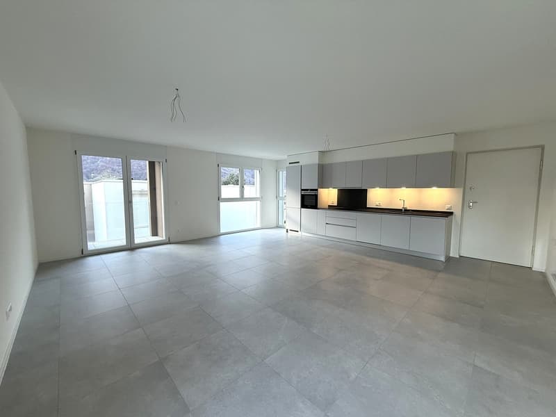 empty kitchen, grey tiled floor, white cabinets, double doors, sliding glass doors
