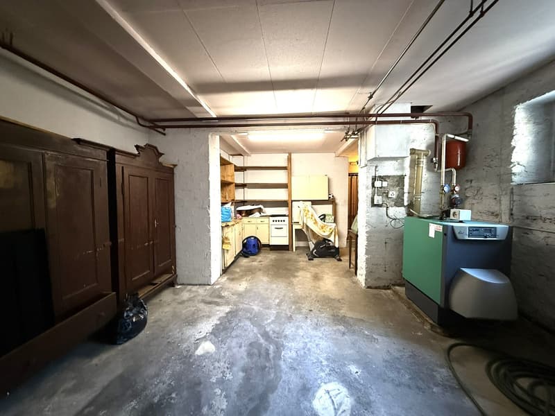 garage with shelves, gas tank, electrical equipment, boiler