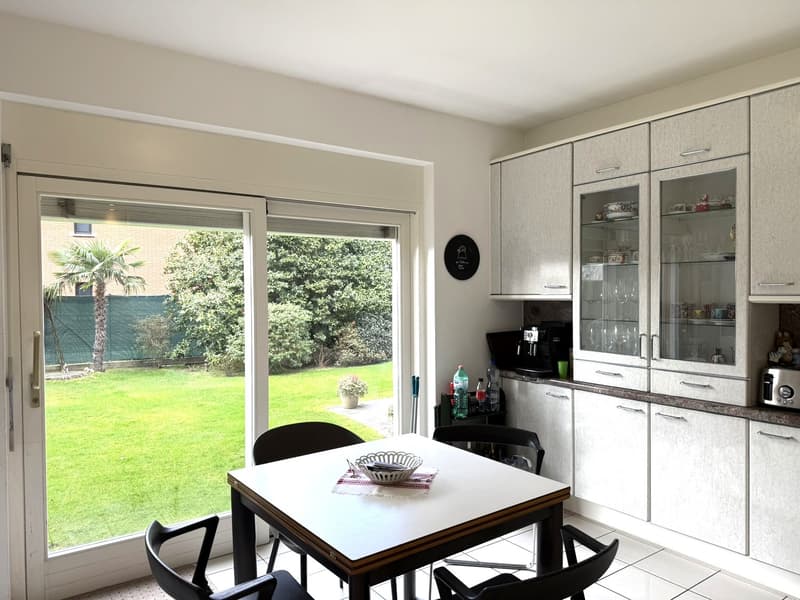 kitchen with dining area, French windows leading to the garden, modern cabinetry, granite countertop